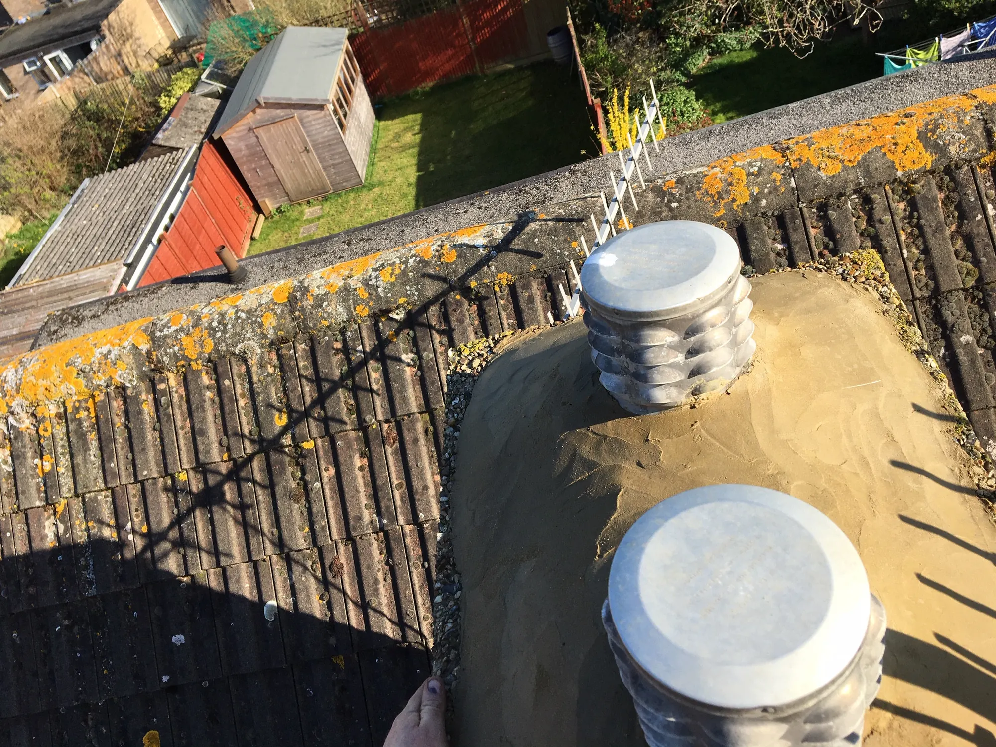 Chimney tops with cowls fitted, roofscape behind